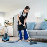 Woman cleaning the carpet