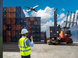 Foreman control loading Containers box to truck for Logistic Import and cargo