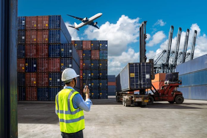 Foreman control loading Containers box to truck for Logistic Import and cargo