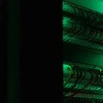 a rack of electronic equipment in a dark room